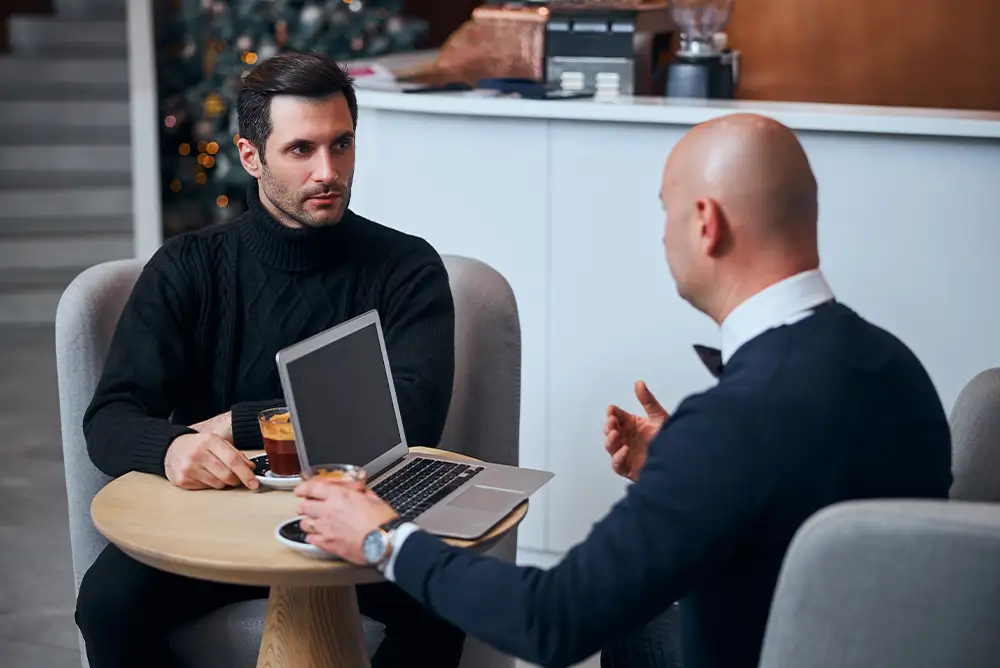 Real estate agent consulting with an SEO specialist.