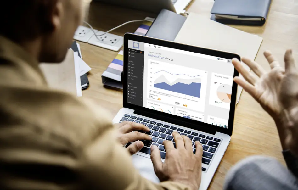 Business owner reviewing travel ad performance on laptop