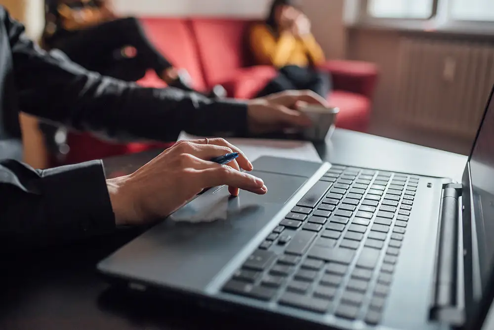 An agent comparing ad results with organic traffic reports in a home office setting.
